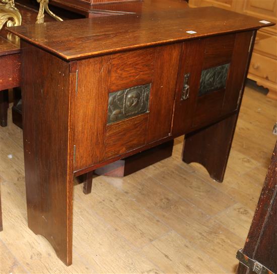 An early 20th century Arts & Crafts oak two door cupboard W.101cm